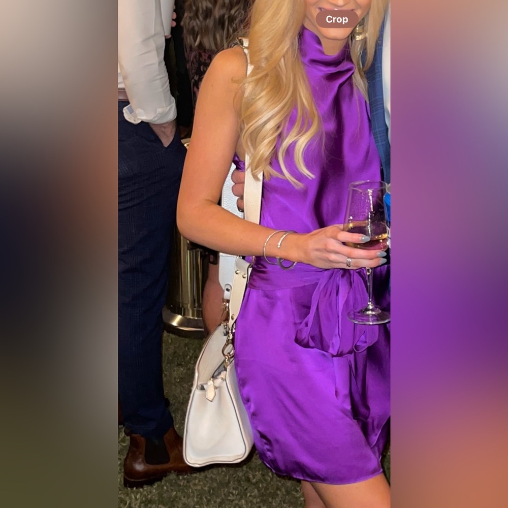 Vibrant Purple Dress with Chic White Bag